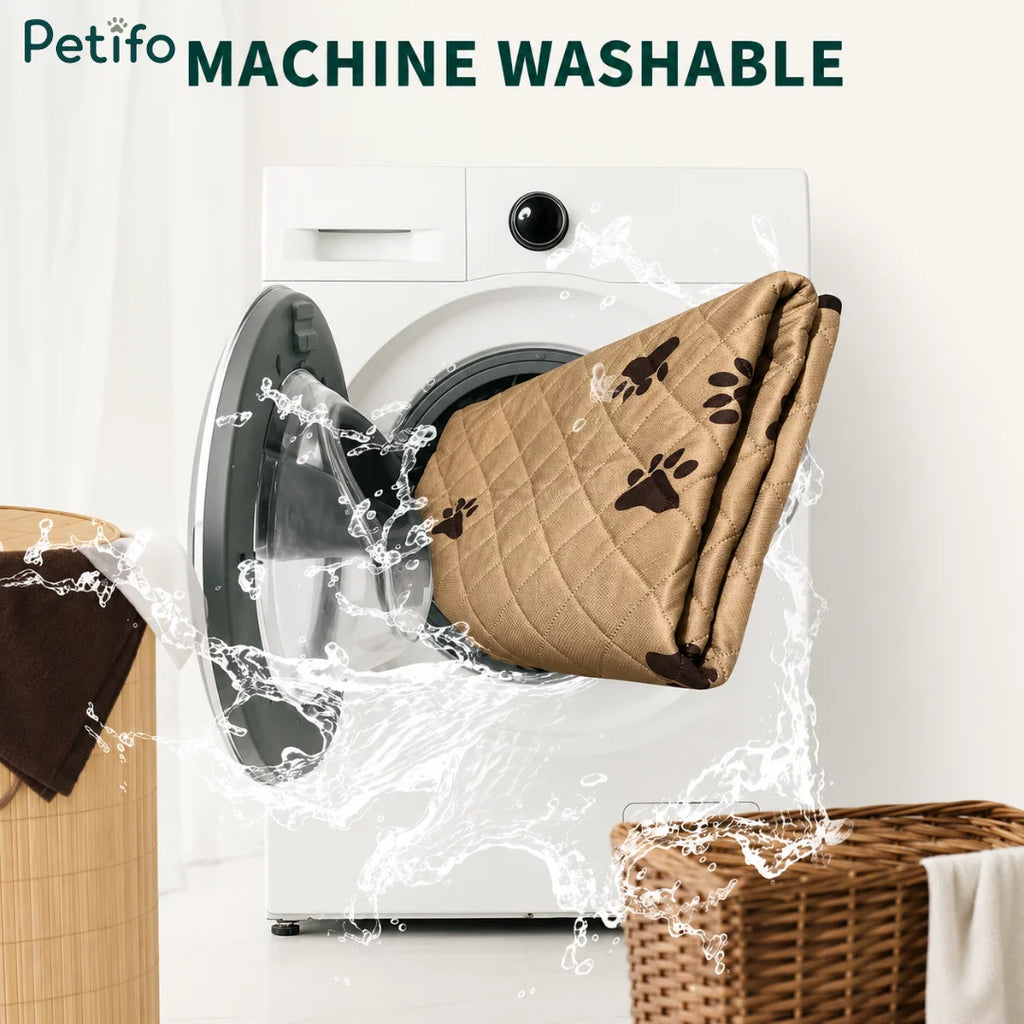 A quilted beige pet training mat spinning inside a modern white washing machine for easy cleaning.