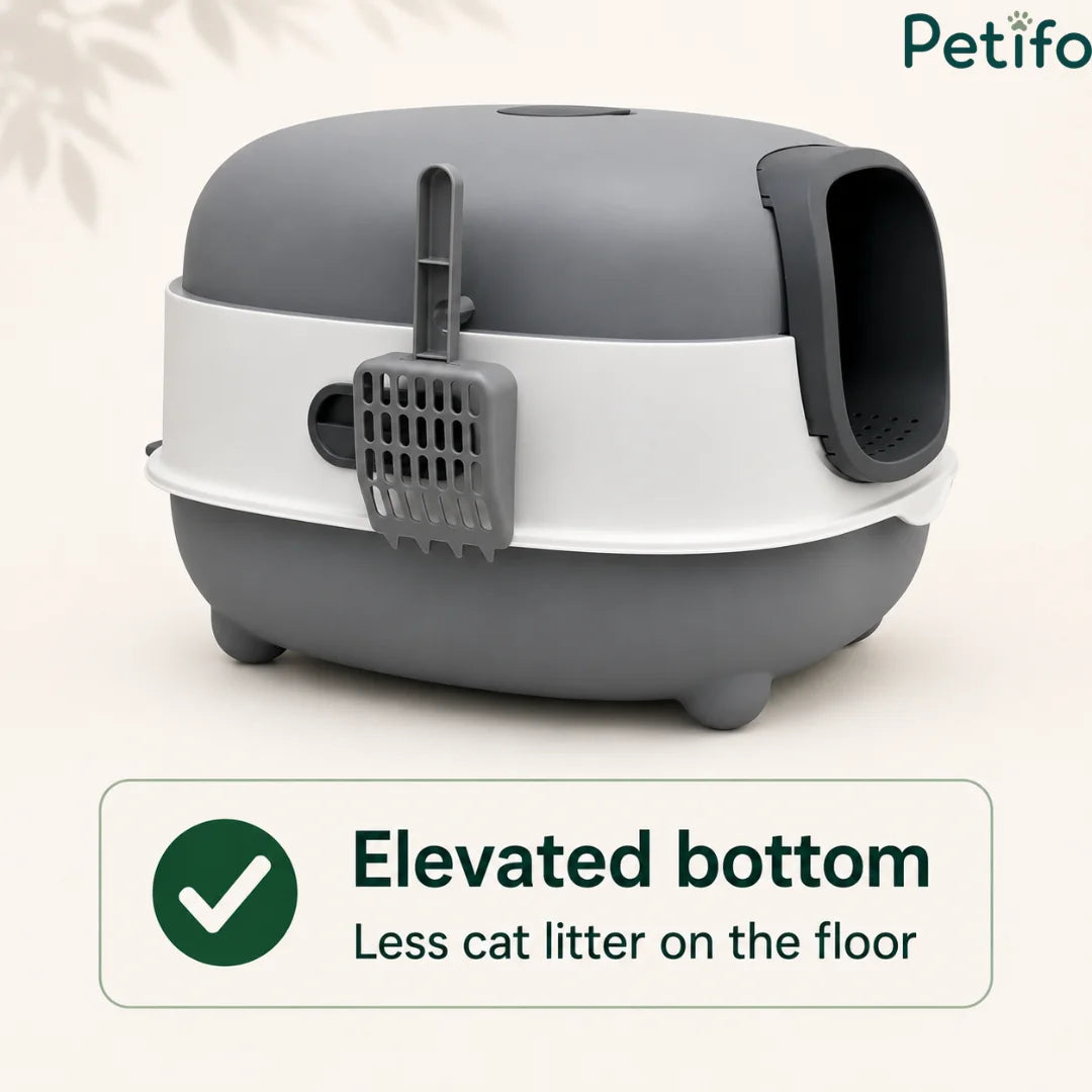 Side view of the grey and white covered litter box highlighting its elevated bottom and attached hanging scoop.