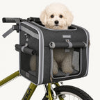 Fluffy white puppy sitting happily inside the Petfuled bicycle pet bag mounted on a green bike.