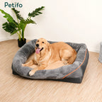 A happy golden retriever resting comfortably in a spacious, grey, and soft-bolstered Petifo orthopedic pet bed.