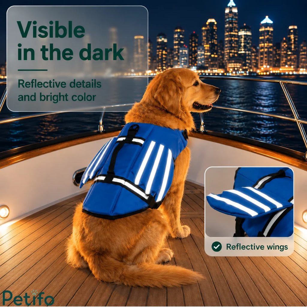 Golden Retriever sitting on a boat at night showcasing the bright blue color and high-visibility reflective wings of its life jacket.