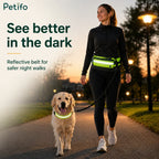Woman walking her dog at dusk with a high-visibility reflective running belt and matching dog collar for night safety.