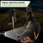 Two huskies sitting outdoors while a flashlight illuminates the highly reflective details of the safety dog leash.