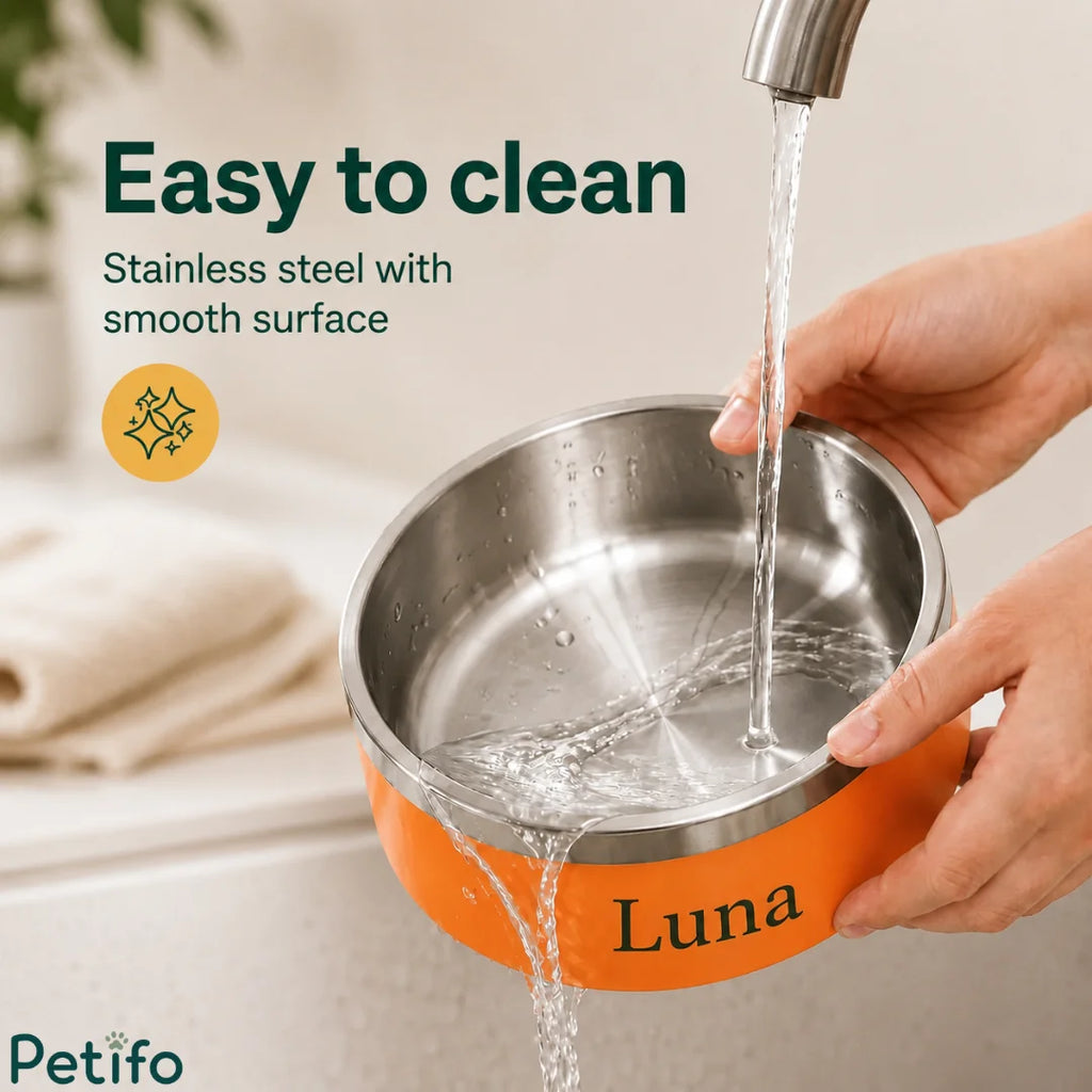 Running tap water rinsing clean the smooth stainless steel interior of a personalized orange pet food bowl.