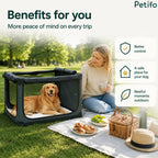 Happy woman enjoying a peaceful park picnic while her golden retriever relaxes securely inside an outdoor pet crate.