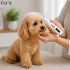 A person trimming the facial hair of a fluffy light brown dog using a white Petifo electric pet hair trimmer.