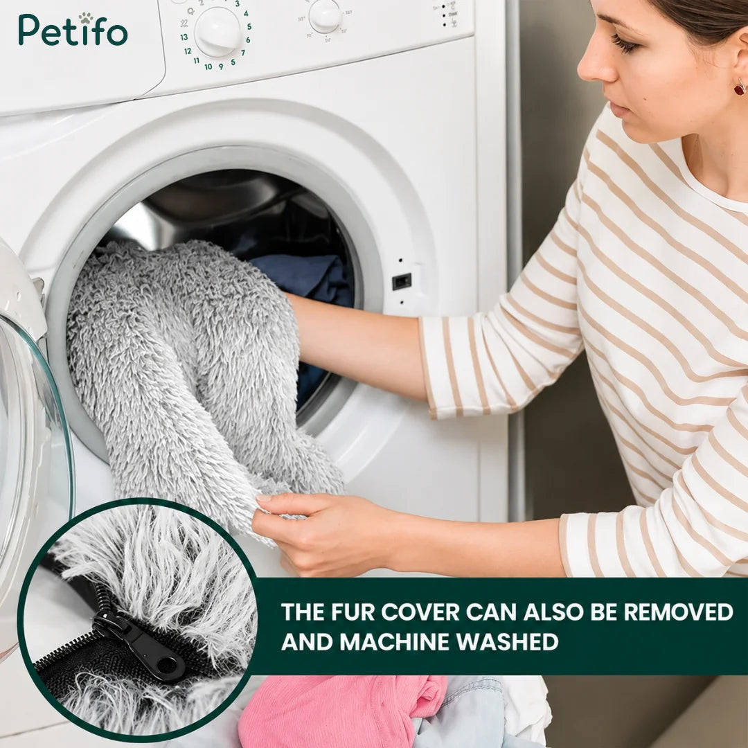 Woman loading the removable faux fur cover of a large dog bed into a washing machine.