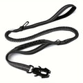 Black shock-absorbing bungee dog leash with a heavy-duty carabiner and comfortable traffic handle on a white background.