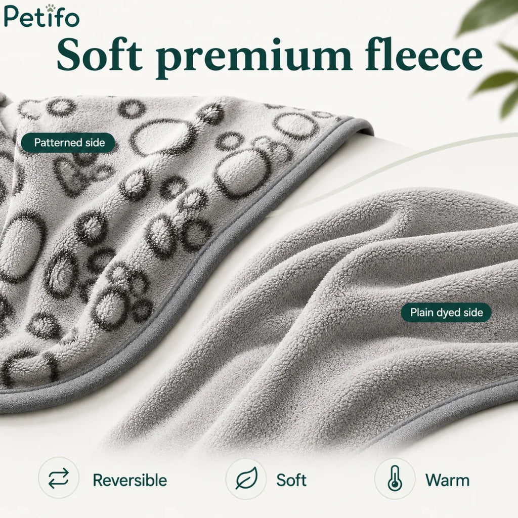 Reversible grey pet blanket displayed to highlight its soft patterned side and plain dyed side.
