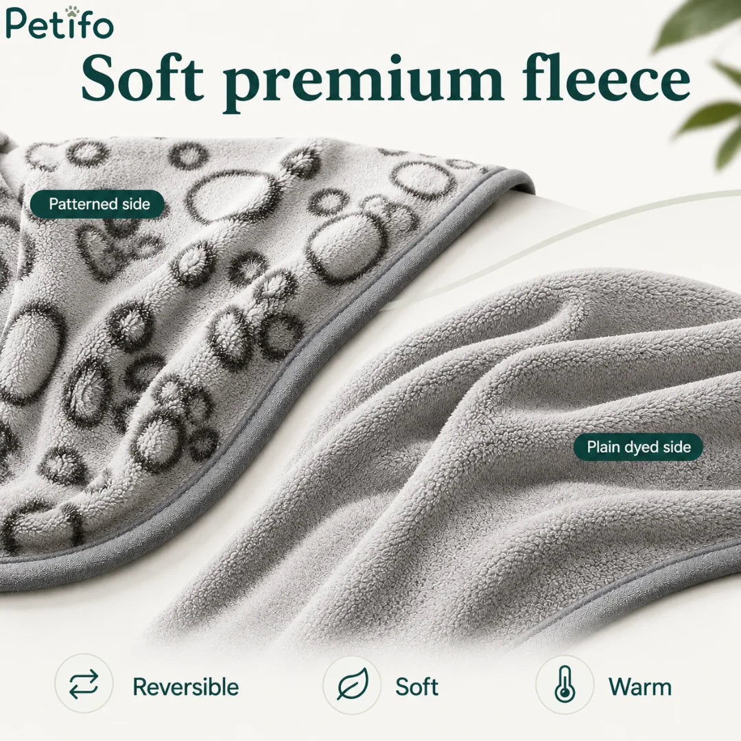 Reversible grey pet blanket displayed to highlight its soft patterned side and plain dyed side.