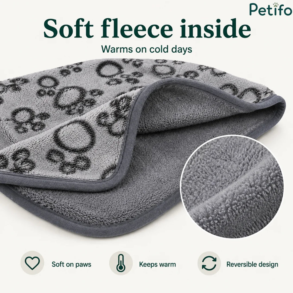 Close-up of a soft grey fleece pet blanket highlighting its warm plush interior and reversible design.
