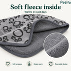 Close-up of a soft grey fleece pet blanket highlighting its warm plush interior and reversible design.