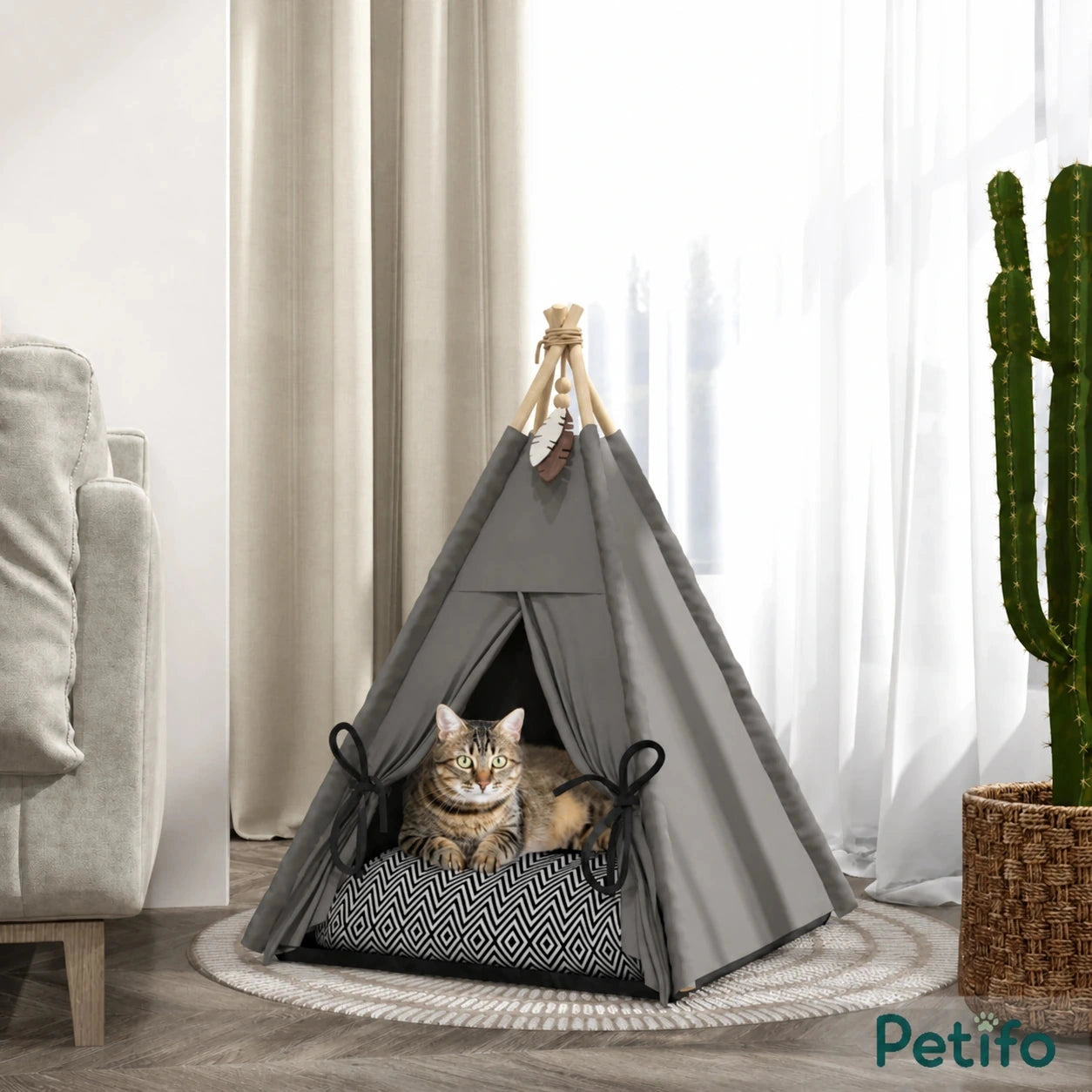 PawHut teepee pet bed: Cat resting in the grey teepee bed beside a sofa - Petifo